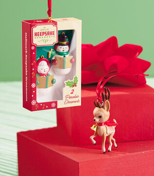 Four holiday-themed ornaments that are part of an ornament series.
