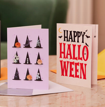 Card with nine decorated witch hats and card with Happy Halloween' on the front. 