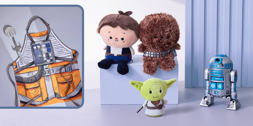 A Star Wars X-Wing grilling apron, Han Solo and Chewbacca and Yoda plush, and an R2D2 calendar figurine
