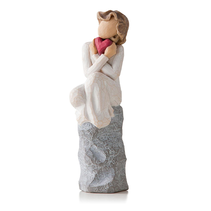 Willow Tree woman embracing heart on a rock