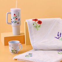 Delicate wildflower floral patterns on white blanket, mug and water cup