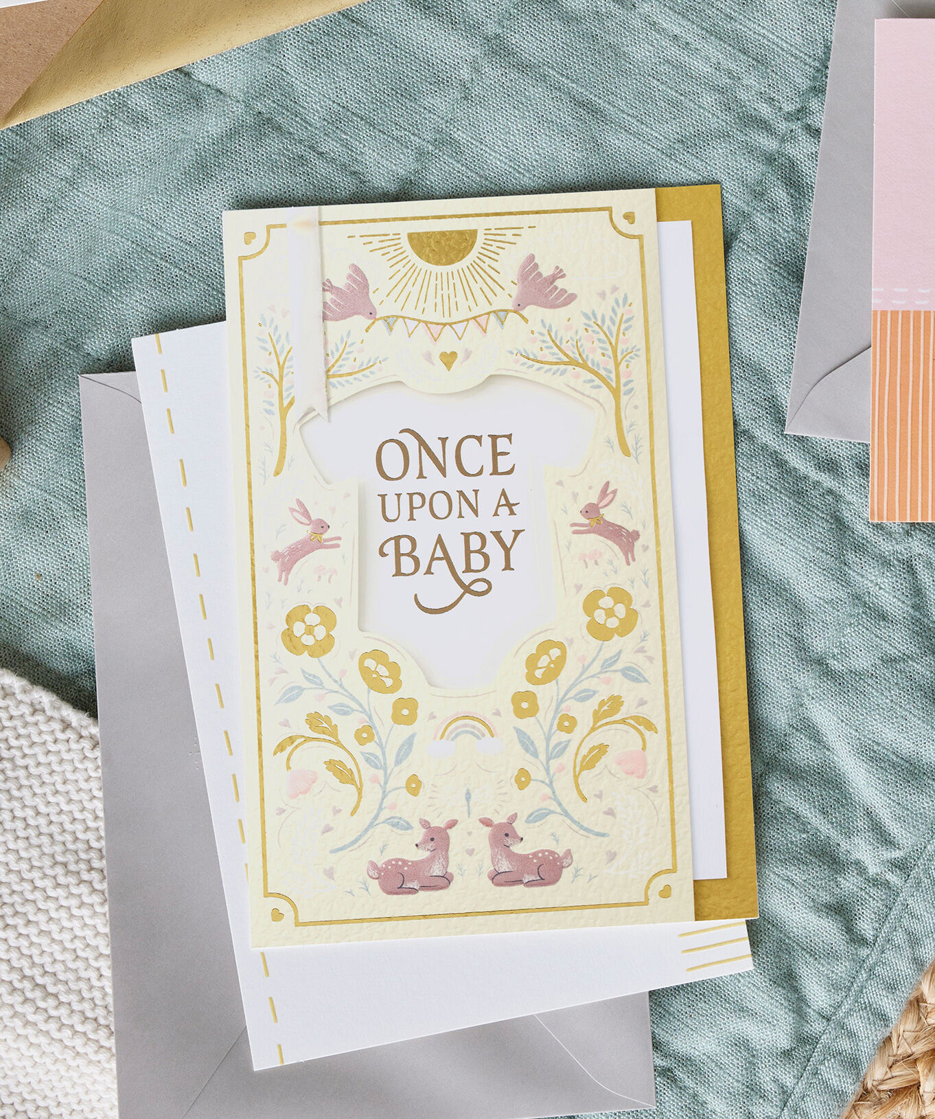 Light yellow card with "Once upon a baby" in a small onesie. 