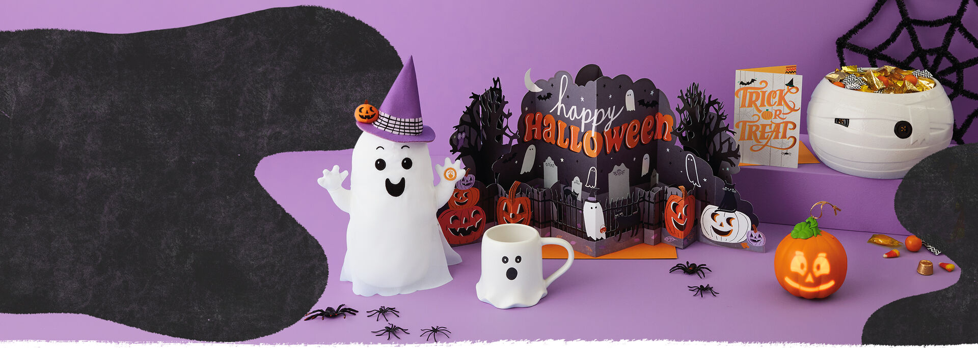 A collection of Halloween products including cards, home decor, candy bowls and treat bags.