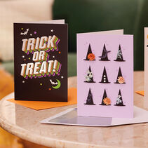 Two Halloween cards standing up on a table.