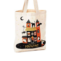 Canvas tote with a haunted house and “Happy haunting” in black, orange and yellow