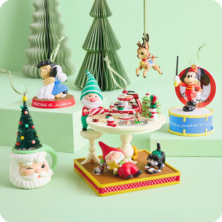 Various Christmas-themed ornaments on a mint green background