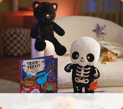 Cat and skeleton stuffed animals and a trick or treat book.
