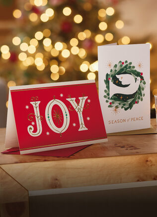 Joy card and Season of Peace card standing up on a table.