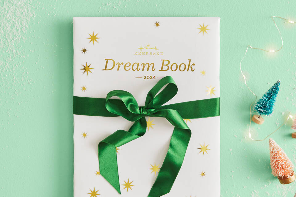 A Dream Book wrapped in white paper & green ribbon