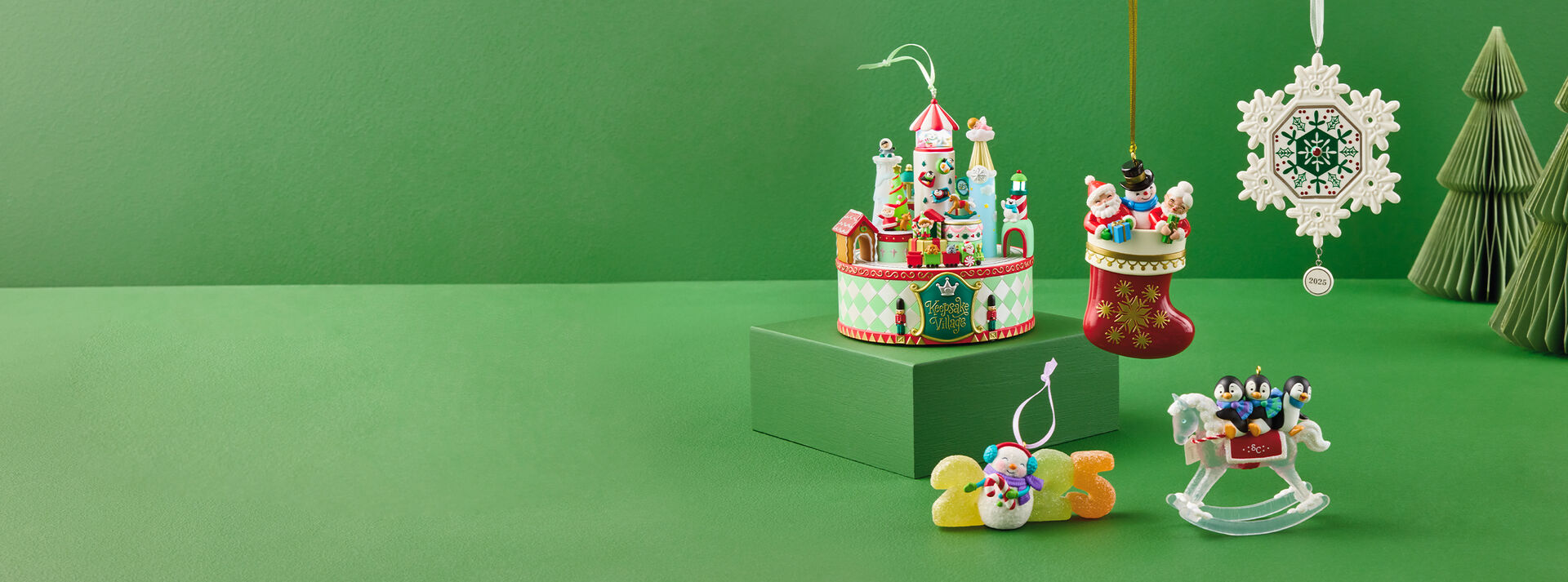 Various sculptural Keepsake Ornaments on a green background