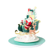 Pop-up card of Santa in a sleigh with a reindeer delivering packages