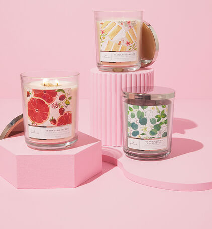 Three versions of the 3-wick candles on a pink background