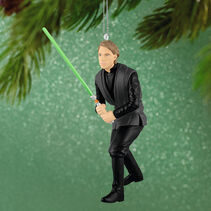 Luke Skywalker holding a green lightsaber ornament.
