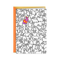 Easter card with white rabbits and one multicolor rabbit on the front.