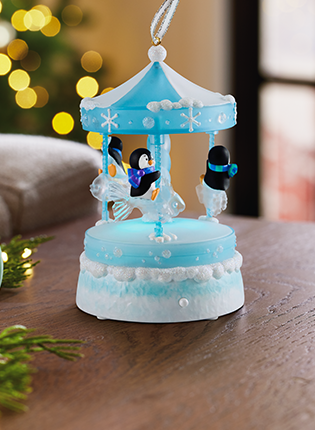 Penguins riding glass fish on a winter themed carousel