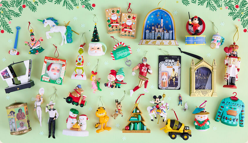 Multiple Christmas-themed ornaments laid on a mint green background.