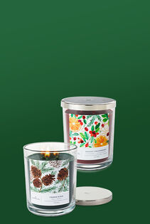Lit three-wick candle in glass jar with lid