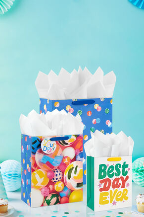 Three gift bags on a table
