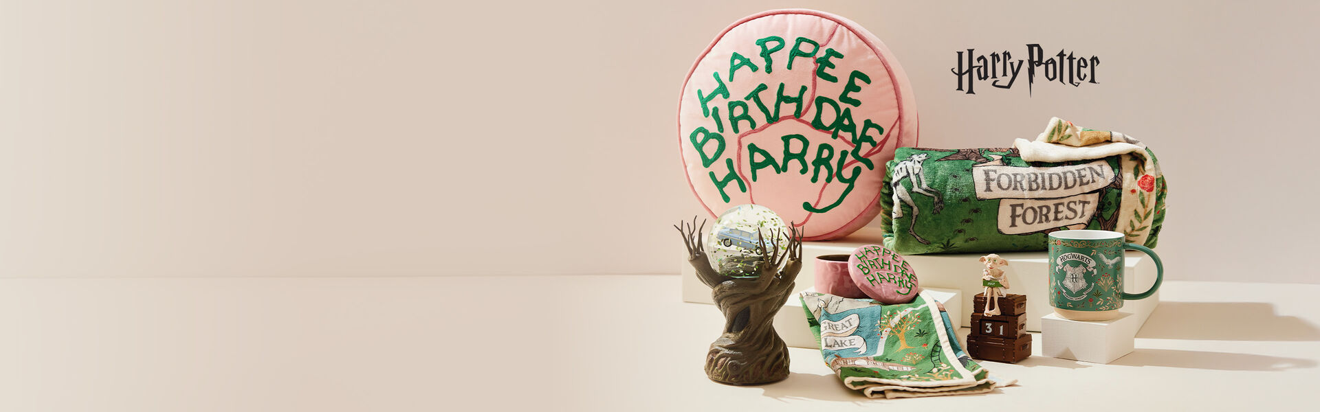 Harry Potter&trade;-themed gifts and decor on a tan background.