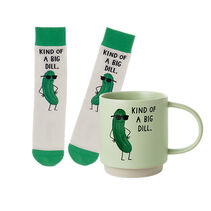 a pair of socks and a coffee mug both with a illustration of a pickle wearing sunglasses with Kind of a big dill'