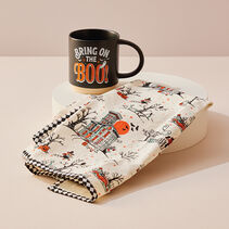 Halloween-themed mug and kitchen towel.