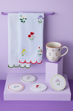 White mug, tea towels and coasters with delicate florals.