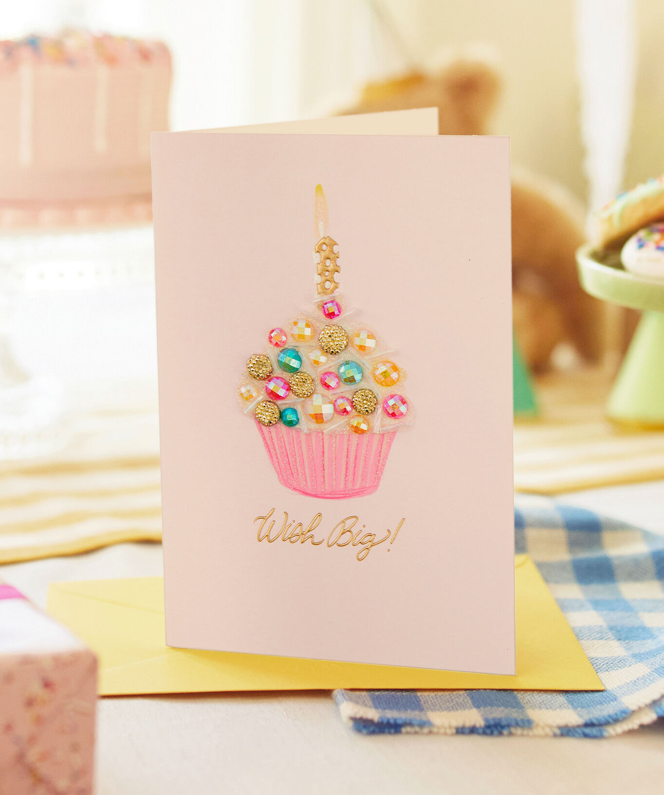 Pink card featuring a cupcake with candle and text Wish Big!'.
