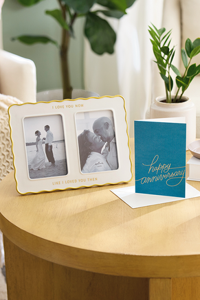 Anniversary picture frame and greeting card displayed on a table