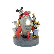 Mickey, Minnie, Donald, and Goofy around a rocket figurine.