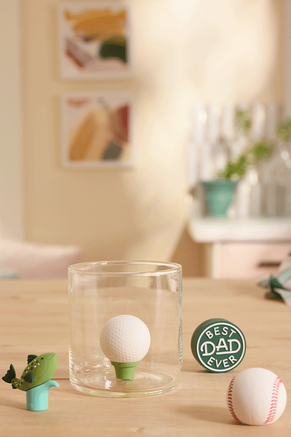 Charmers drinkware accessories, including a golf ball, baseball, fish and "best dad ever"