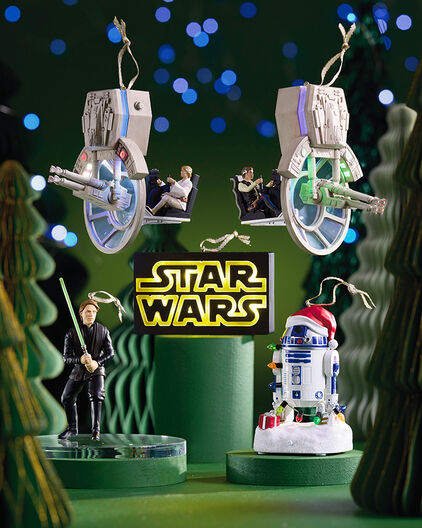 Star Wars ornaments on a green background.