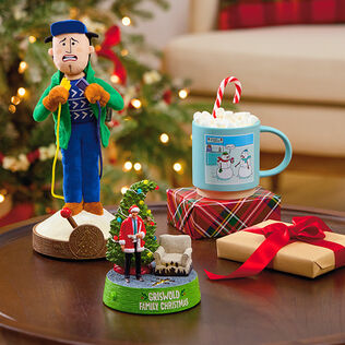 Tree lighter, Griswold family Christmas ornament, and cocoa mug on a table.