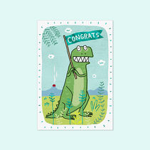Greeting card with illustration of a Tyrannosaurus Rex dinosaur holding a shiny, green foil flag in a prehistoric jungle