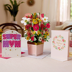 A card that reads "super mom," a card that reads "Happy Mothers Day," and a pop-up card of a flower bouqet