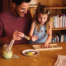 Father and daughter doing a craft together