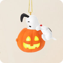 Snoopy looking into a jack-o-lantern ornament