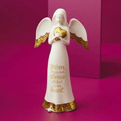 An angel figurine with a painted-on message that reads "Mom keeps our stories etched in her heart"