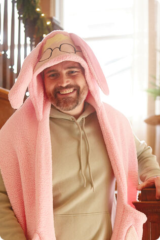 Bearded man wearing a hooded Ralphie scarf with pockets.