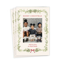 Flat card with your photo bordered by illustrated green garland, berries and a red bow red lettering