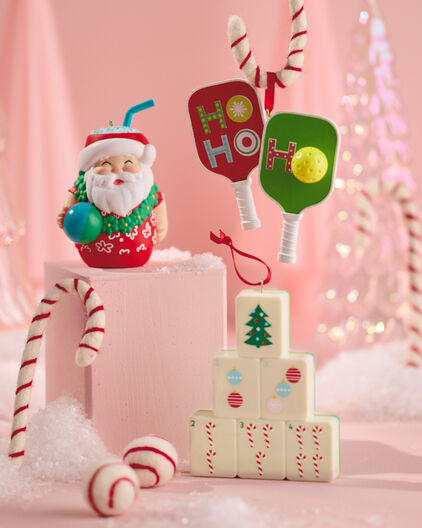 Christmas themed pickleball, mahjong, and pina colada ornaments.