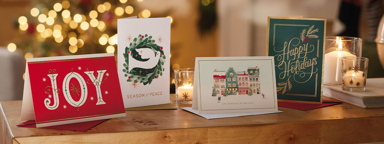 Various holiday cards stood up on a table.