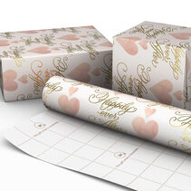 Wrapped gifts and paper roll with hearts and happily ever after on blush background