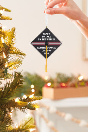 Hand in front of lit tree holding Graduation Cap Personalized Ornament with Custom Text
