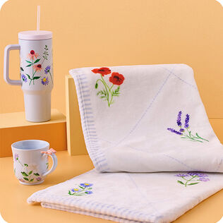 Delicate floral patterns on white blanket, mug, and water cup.
