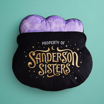 Black cauldron-shaped pillow with purple bubbles embroidered with Property of Sanderson Sisters in white and gold.