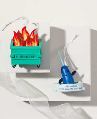 A dumpster fire and narwhal ornaments on a white background.