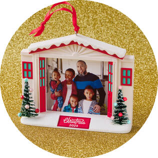 An ornament featuring a family picture with the caption "Christmas 2024"