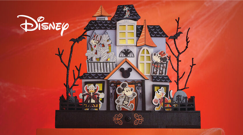 Haunted house table top decor with Mickey, Minnie, Goofy, Donald and Pluto in costumes