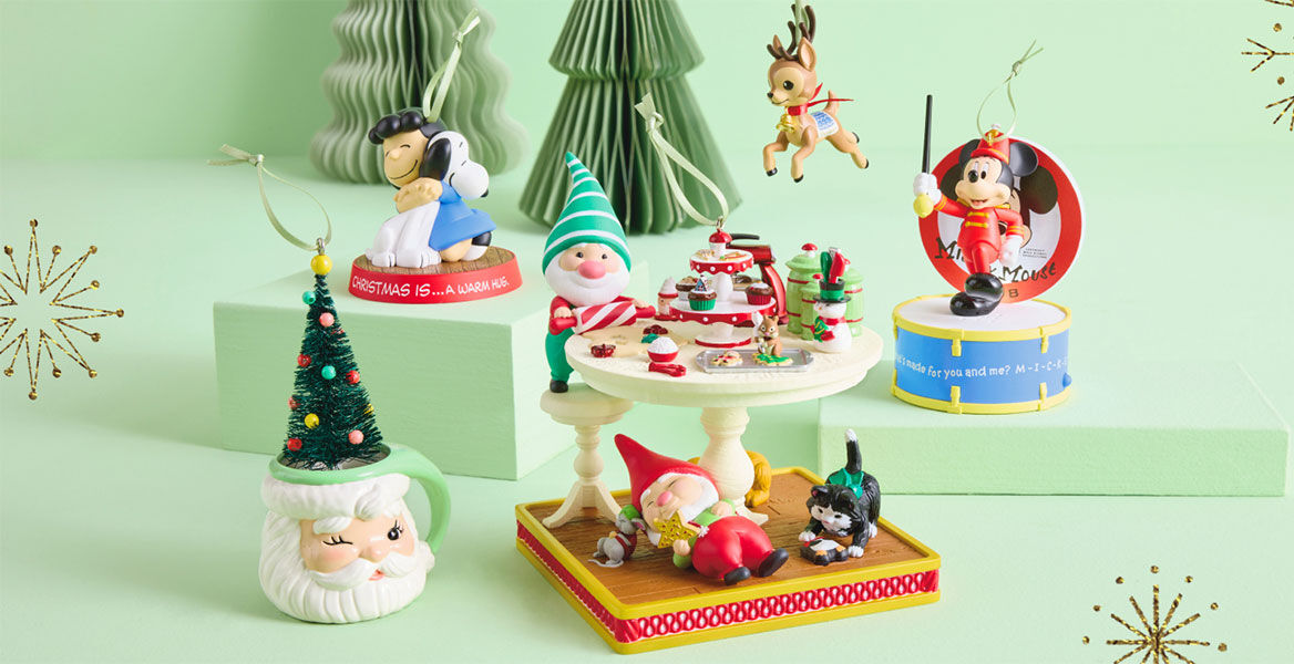 Five Christmas-themed ornaments on a mint background