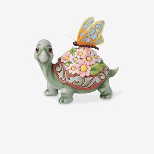 Turtle and butterfly ceramic figurine.